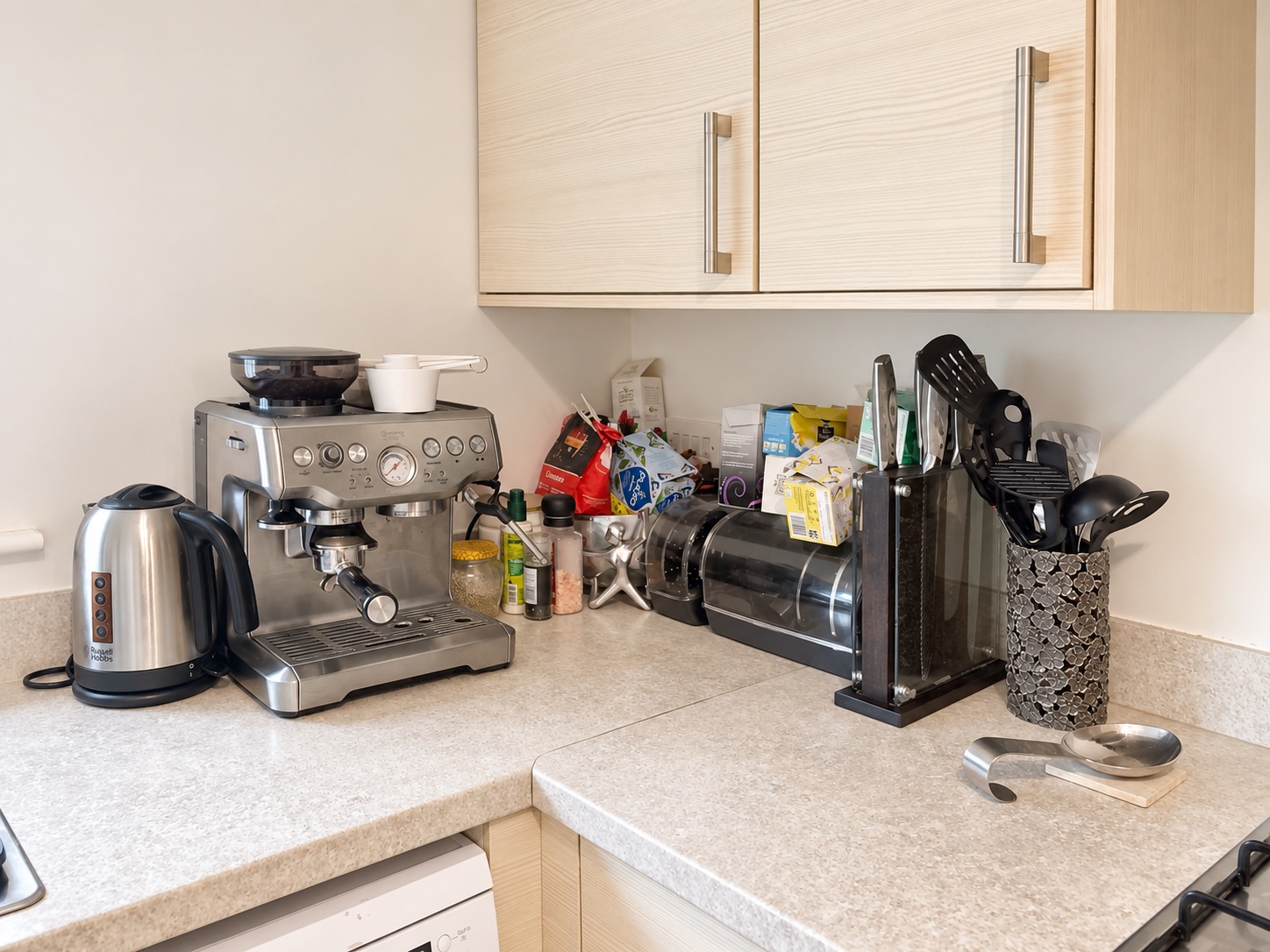 Coffee machine, kettle and worktop corner with original appliances and belongings