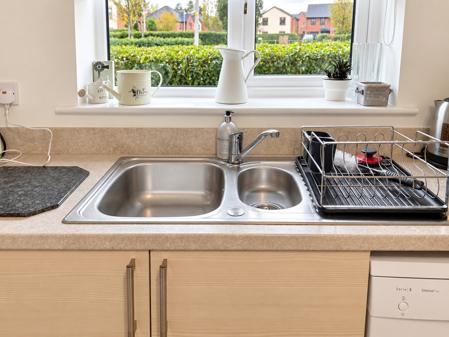 Double kitchen sink and draining rack after cleaning, retaining household items