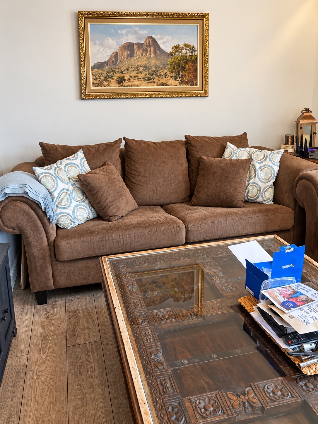 Furnished living room with sofa, glass coffee table and original household belongings